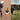 Lifestyle view of the batting tee in use and coach tossing balls to boy on a field