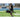 Close up view of male attaching the legs to the back of SKLZ Soccer trainer board at a field